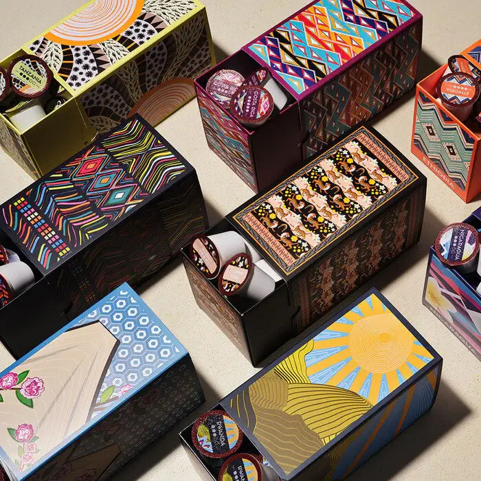 An assortment of colorful boxes containing coffee pods compatible with Keurig 1.0 & 2.0 Machines, all from different coffee origins.